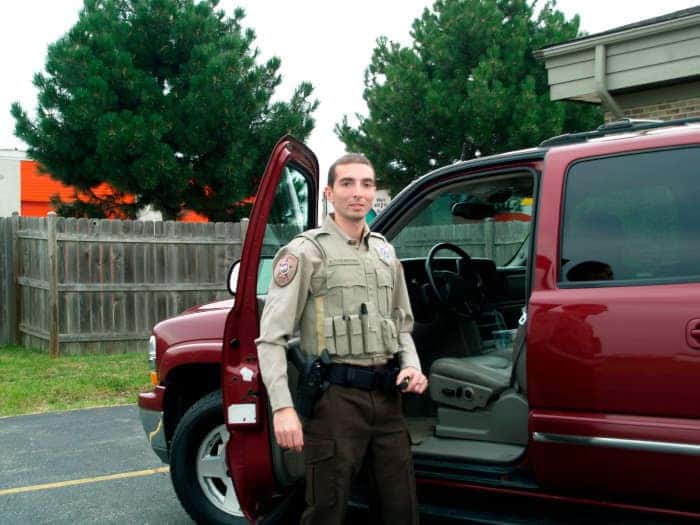 Alex standing next to a 1994 ford explorer