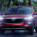 Red 2026 Ford Escape driving in the rain