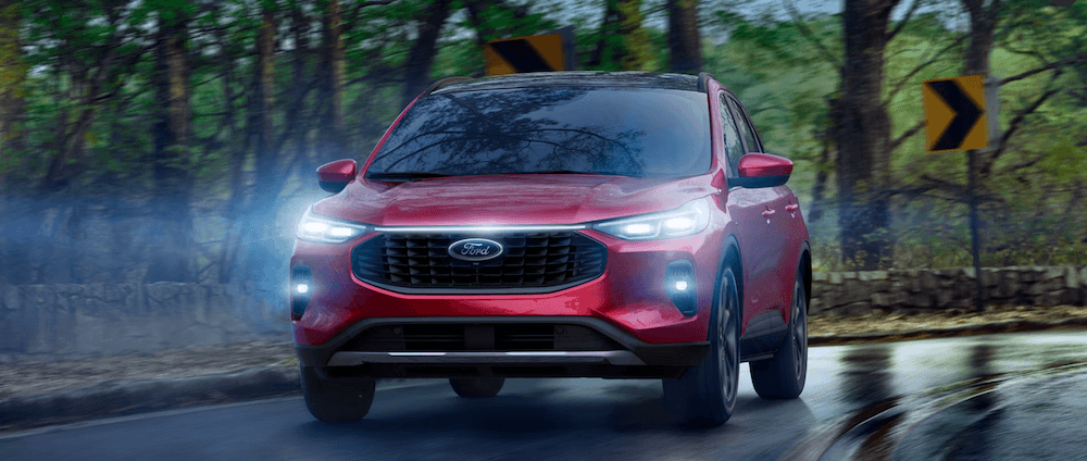 Red 2026 Ford Escape driving in the rain