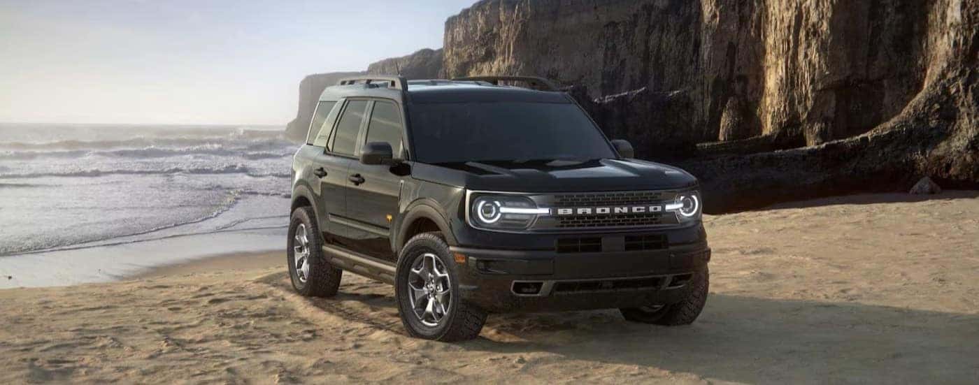 A black 2024 Ford Bronco Sport parked on sand.