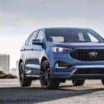 A blue 2019 Ford Edge ST is shown from the front at an angle after leaving a used Ford dealer..