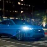A blue 2024 Ford Mustang Mach-E GT is shown from the front at an angle after leaving a Mach-E for sale near Hayward.