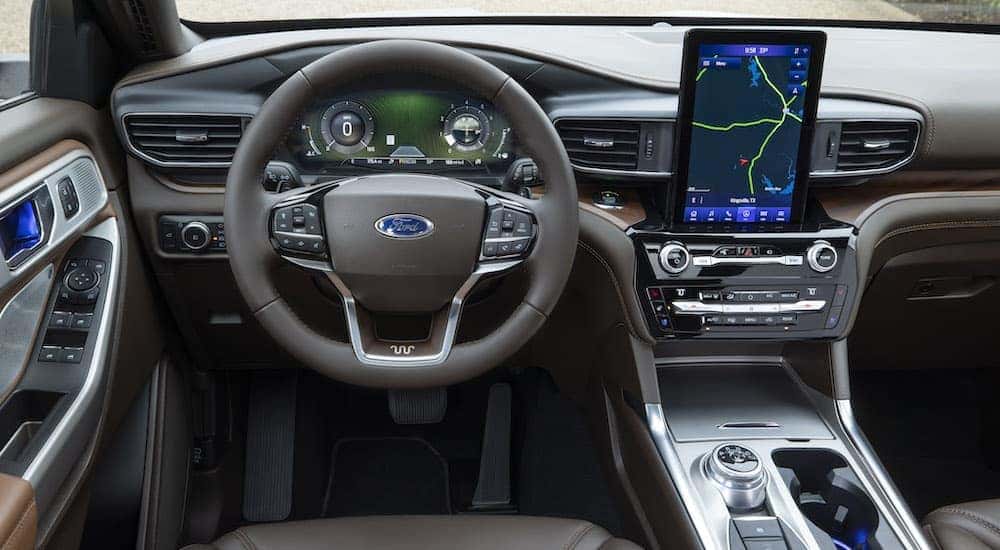 The interior of a 2021 Ford Explorer King Ranch is shown from the driver's seat after leaving a dealer that has SUVs for sale.