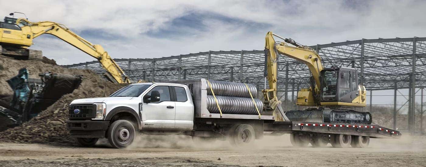 A white 2024 Ford F-450 Super Duty Chassis Cab is at a construction site.