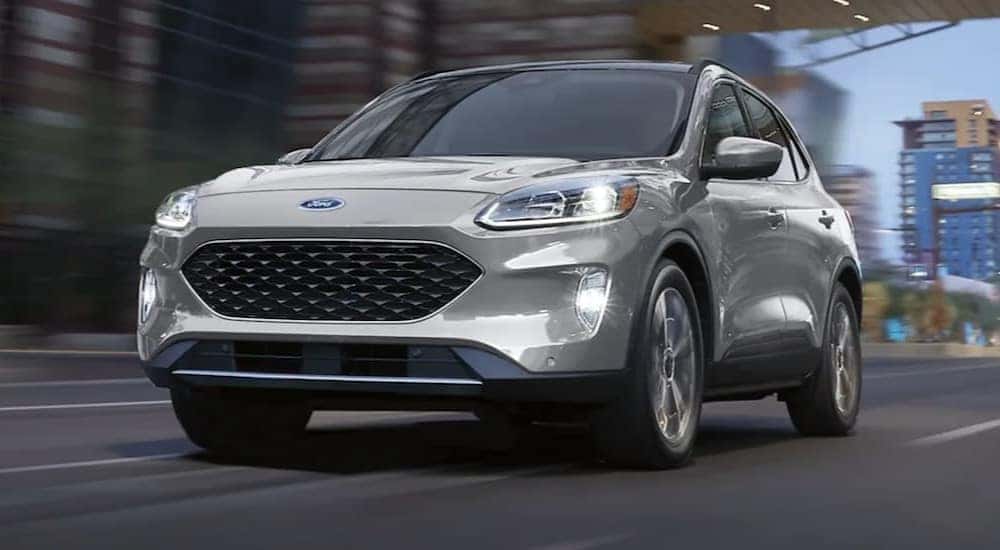 Ground-level view of a silver 2021 Ford Escape, a used SUV for sale.