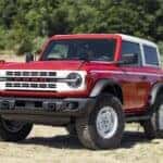 A red 2023 Ford Bronco Heritage Edition is shown from the front at an angle.