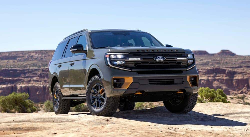 A green 2025 Ford Expedition Tremor parked off-road.