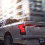 A silver 2025 Ford F-150 Lighting is shown from the rear at an angle after leaving a Ford dealer near Dublin..