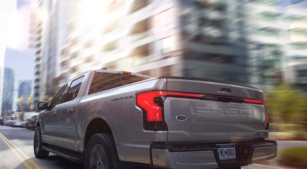 A silver 2025 Ford F-150 Lighting is shown from the rear at an angle after leaving a Ford dealer near Dublin..