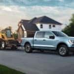 A blue 2022 Ford F-150 Lightning for sale near Oakland towing construction equipment