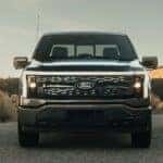 A black 2025 Ford F-150 Lightning for sale near Oakland is parked.