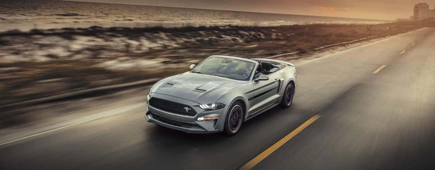 A silver 2020 Ford Mustang California Special is shown on a coastal road after after leaving a Ford dealer near you.