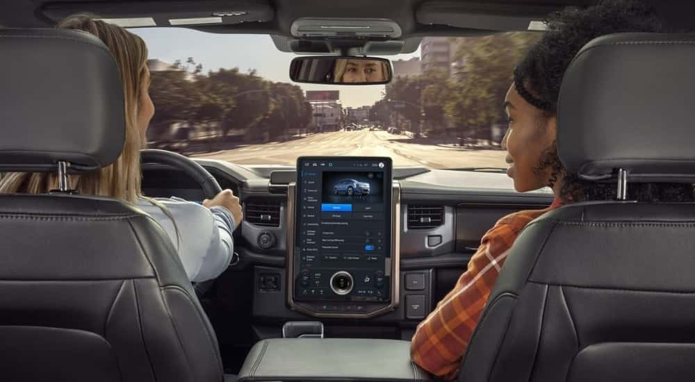 Two women riding in a 2025 Ford F-150 Lightning from a Ford dealer near Hayward