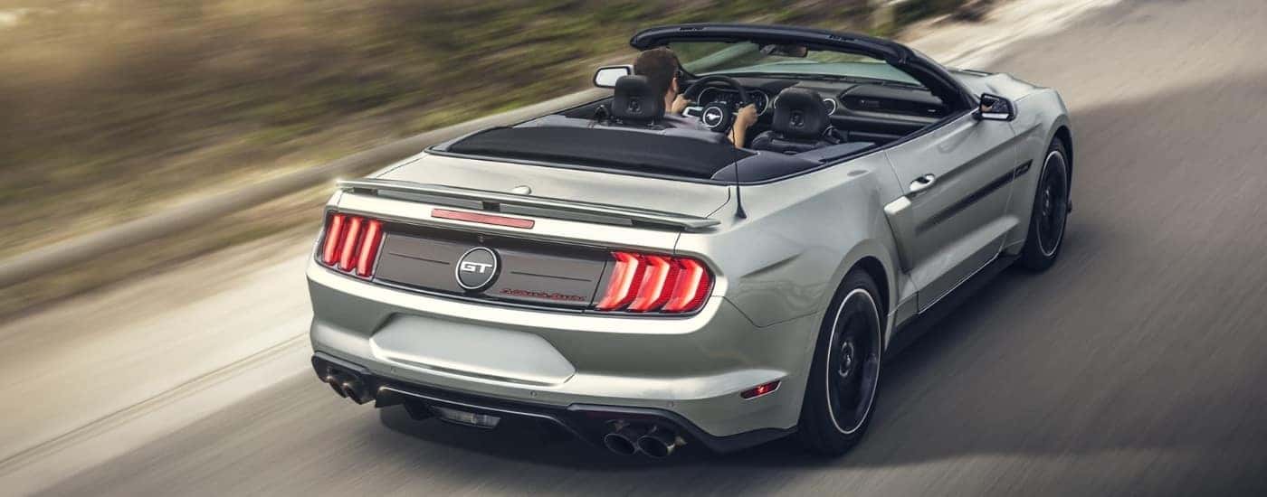 A silver 2020 Ford Mustang GT California Special driving to a Ford dealer near Hayward.
