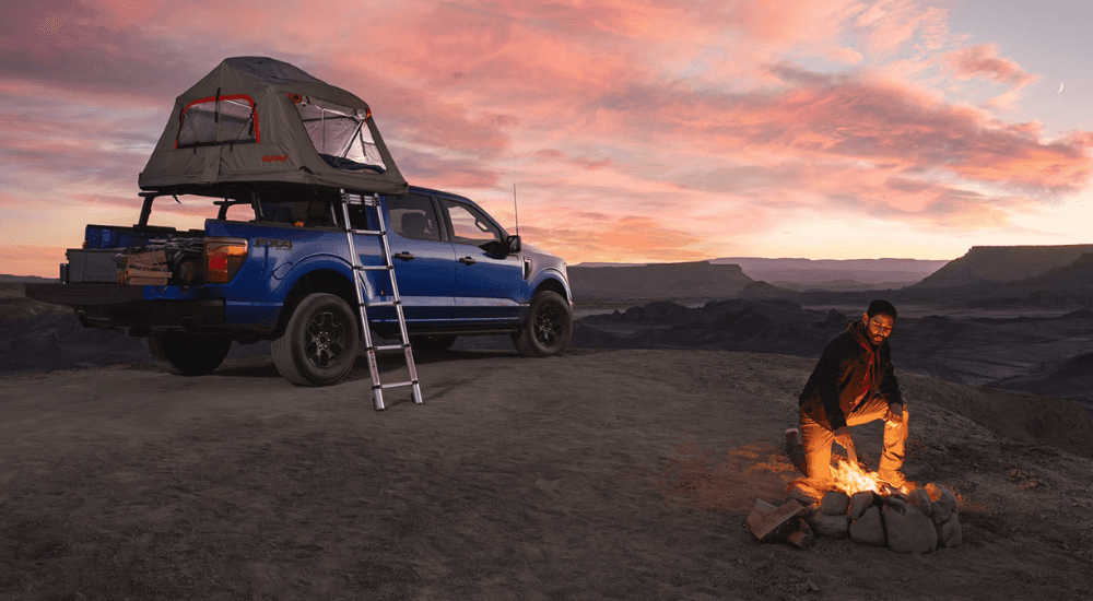Blue 2026 Ford F-150 Fx4 parked on a campsite