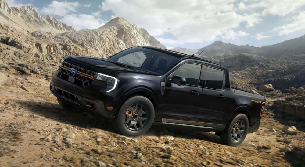 Black 2026 Ford Maverick Tremor driving up a rocky mountainside
