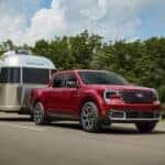 Red 2026 Ford Maverick towing an Airstream Camper