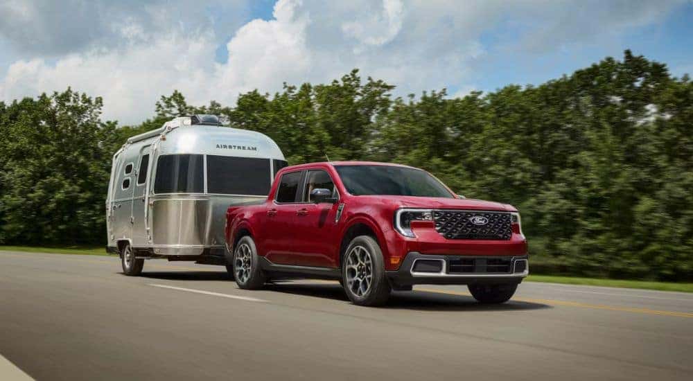 Red 2026 Ford Maverick towing an Airstream Camper