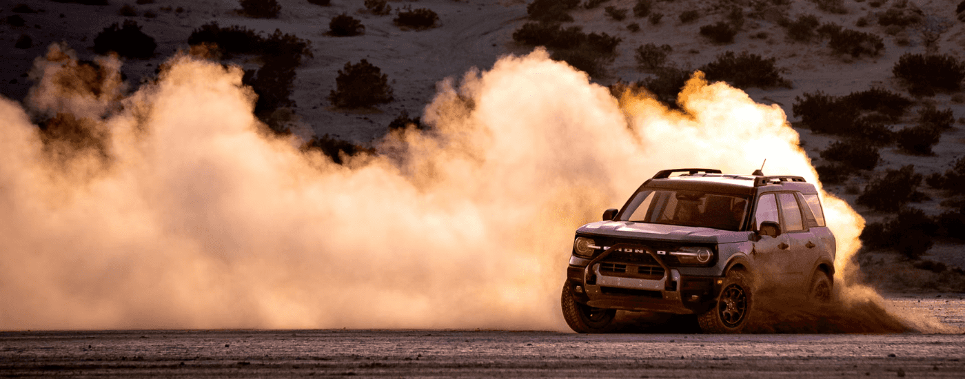 Blue 2026 Ford Bronco Sport drifting and kicking up dust