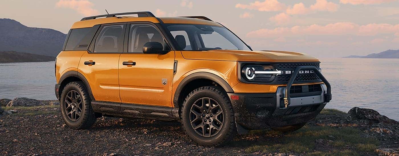 Orange 2026 Ford Bronco Sport Big Bend Black Diamond parked on a coast