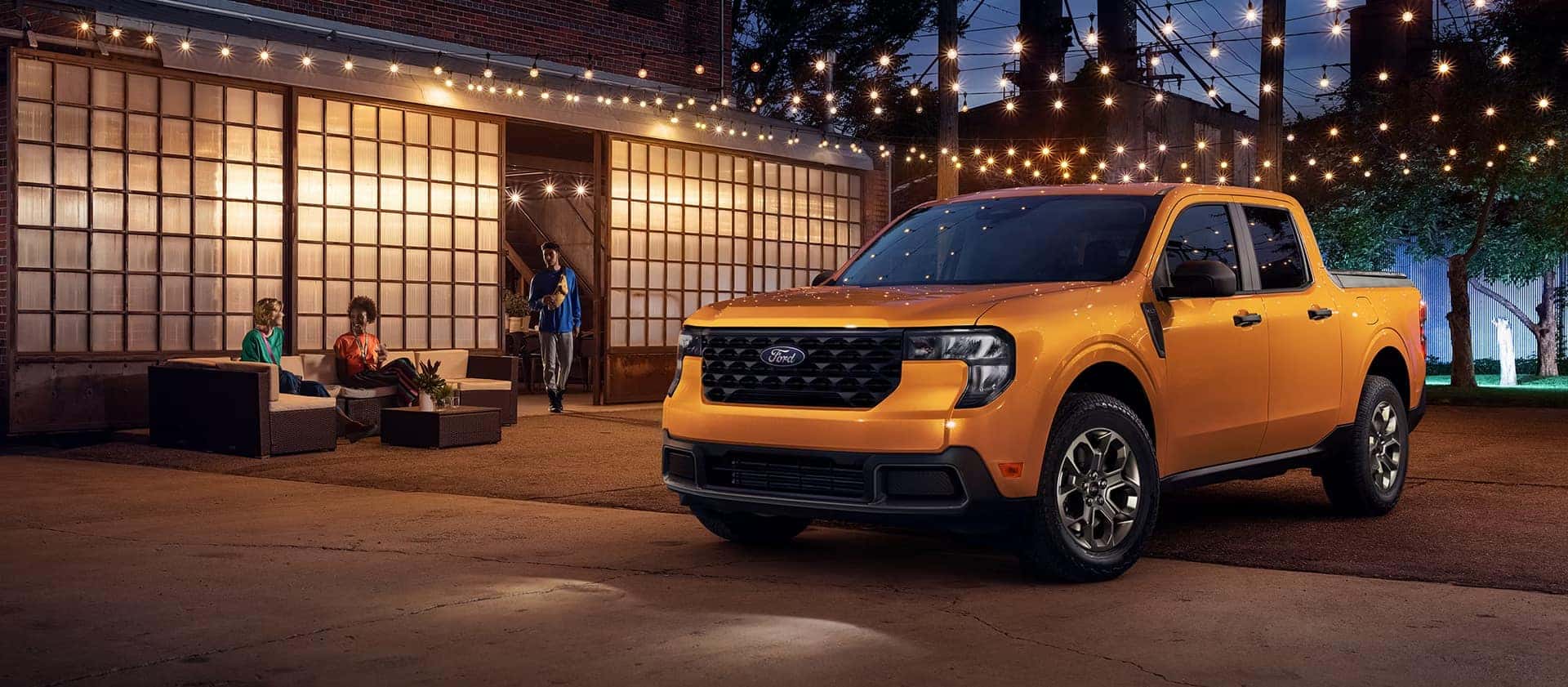 2026 Ford Maverick parked outside home at night with outdoor lighting and patio setting
