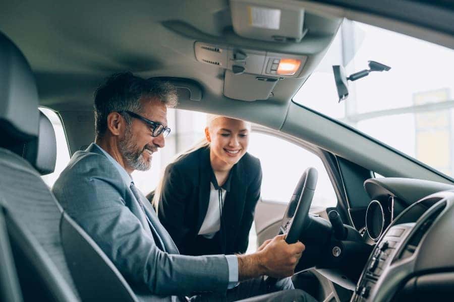 man sitting in the drivers seat of a car
