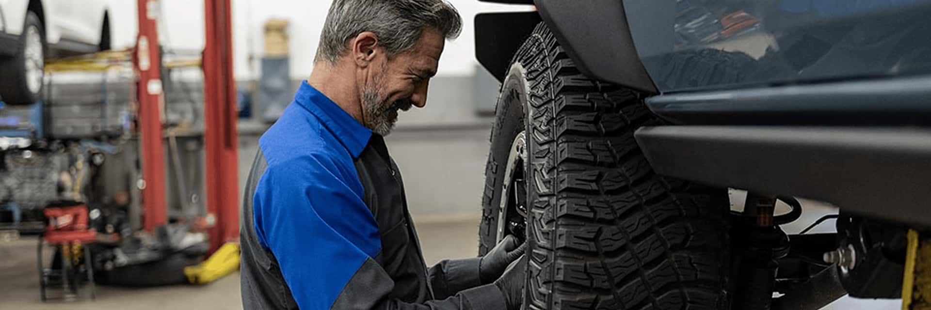 ford service tech working on tire