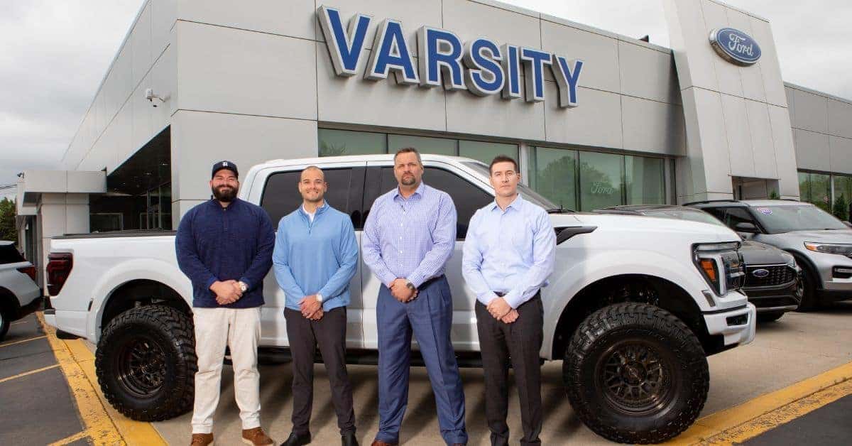 Employees standing in front of Varsity Ford’s dealership in Ann Arbor, MI