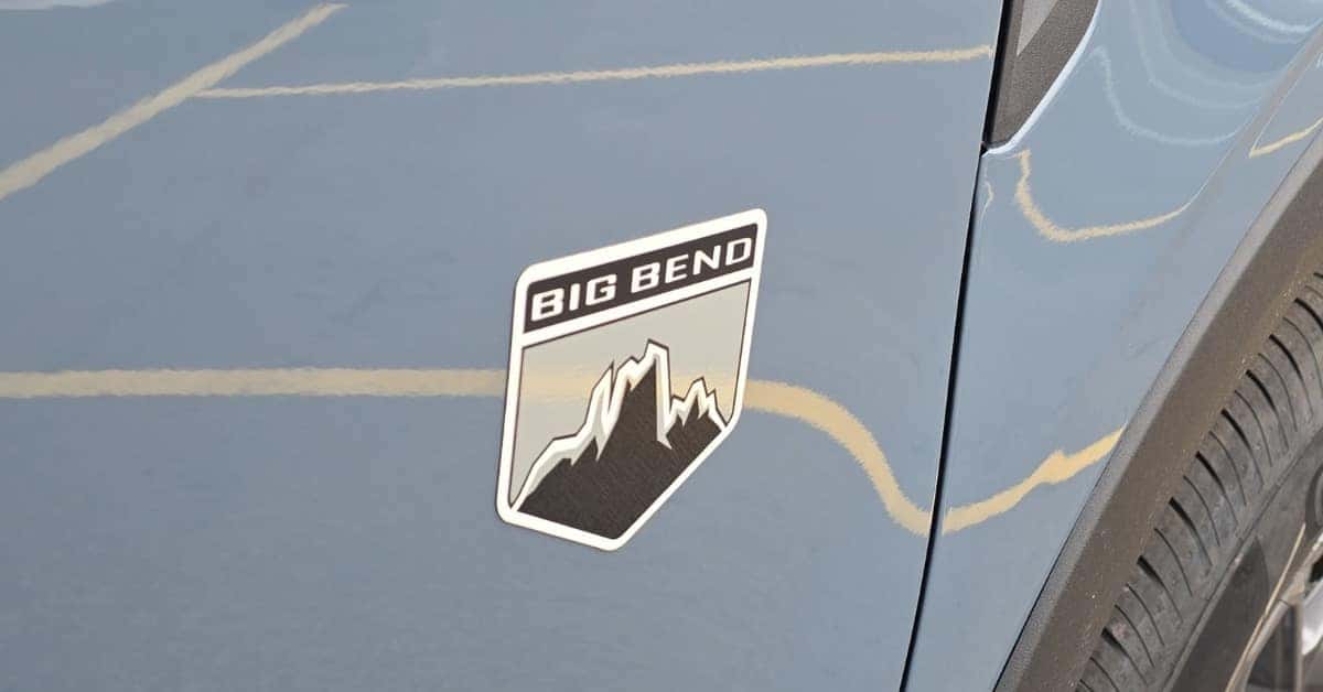 Close-up of the 'Big Bend' badge on a light blue 2026 Ford Bronco Sport, featuring a mountain design on a gray and black emblem, emphasizing the vehicle's adventurous trim level.