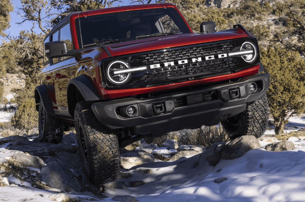 2024 Ford Bronco driving over snow-covered rocks