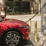 A person charging the 2023 Ford Mustang Mach-E at a charging station