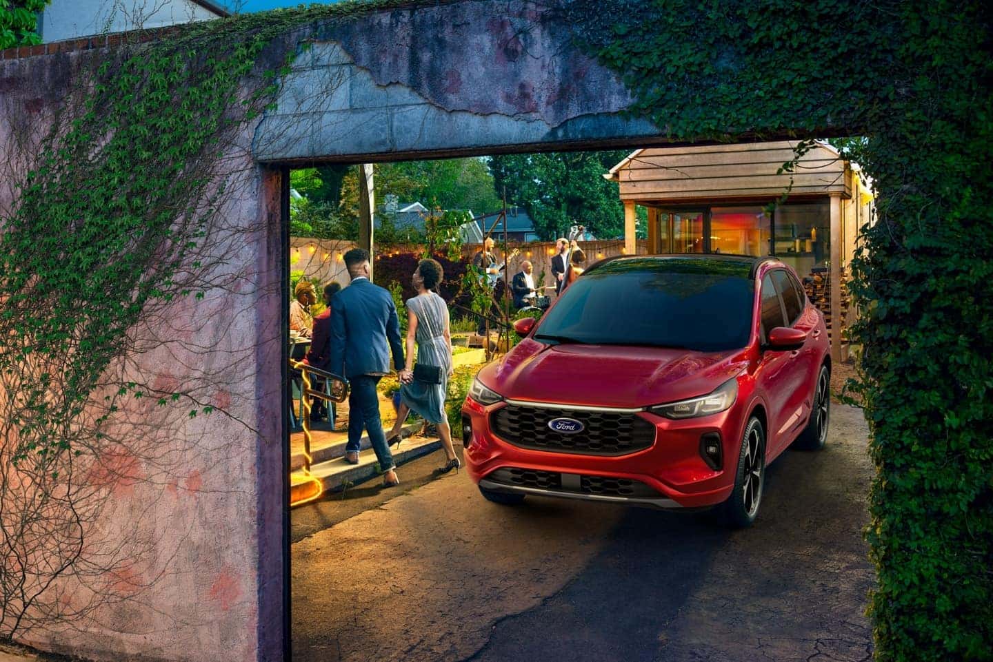 A red 2024 Ford Escape parked in a driveway in a backyard