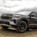 A gray Ford Explorer parked off-road on a dirt ledge