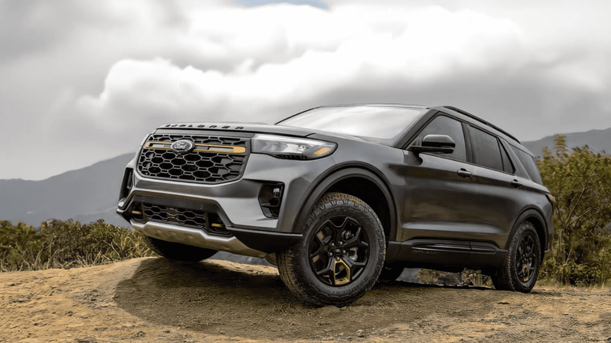 A gray Ford Explorer parked off-road on a dirt ledge