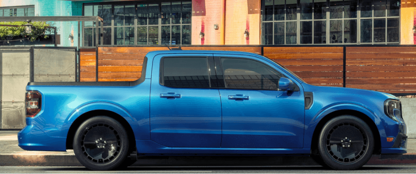 A blue Ford Maverick in profile, parked by the curb