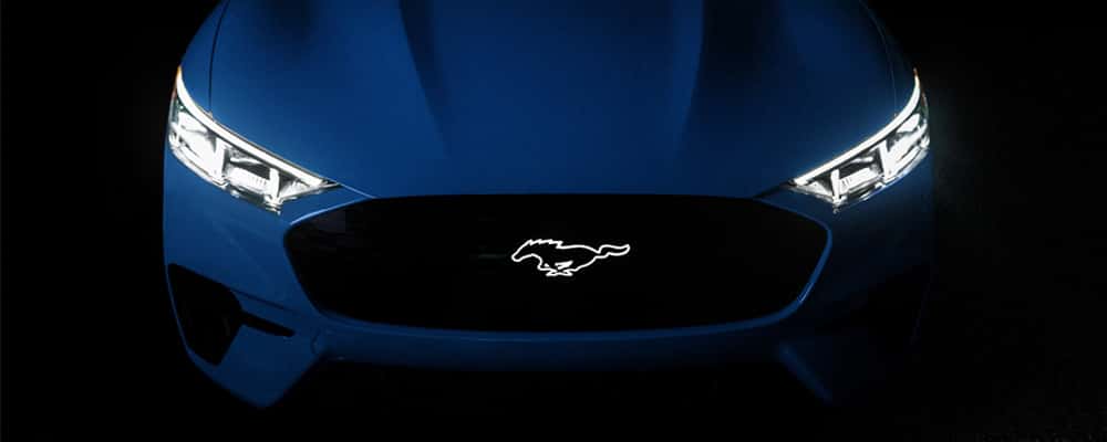 Blue car with headlights and logo on