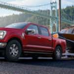 A red truck towing a boat