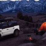 A car parked next to a tent