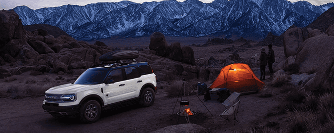 A car parked next to a tent