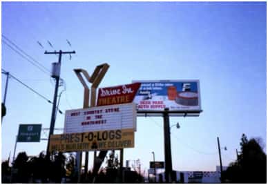 A sign board and telephone poles