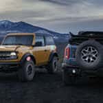 An orange jeep and a black jeep