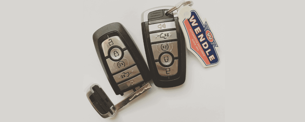 Two Ford key fobs with a Wendle key chain attached.