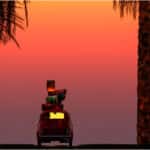 A car driving through trees at sunset