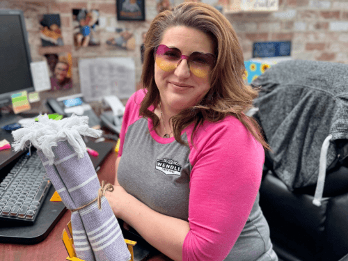 A person sitting at a desk with a stack of paper