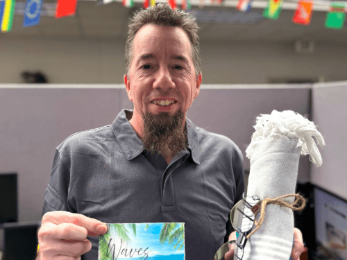 A person holding a card and a towel
