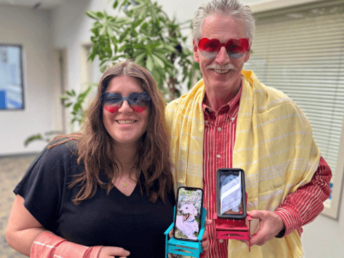 People wearing sunglasses and holding cell phones