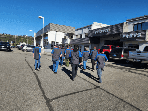 A group of people walking in a parking lot