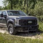 2025 Ford Super Duty driving on a dirt road