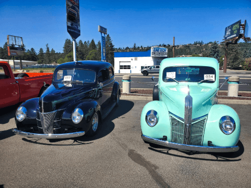 A blue and black car parked in a lot