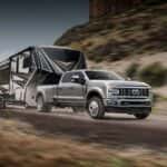 Silver Ford Super Duty hauling a camper